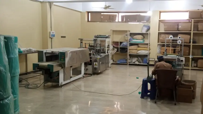 Sachet production floor at the DryGelWorld factory in Karachi with sachet-making machines and an operator