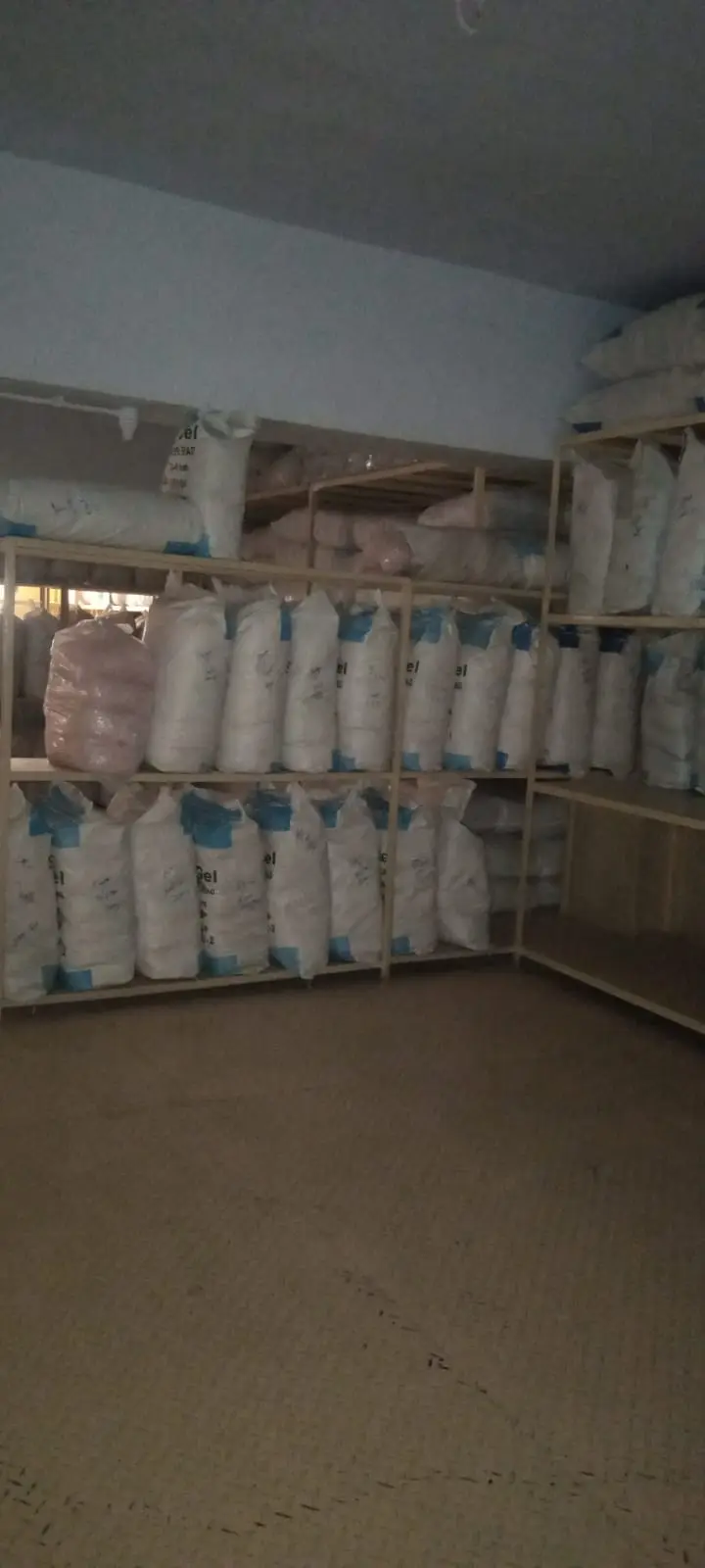 Store-room shelves stacked with white bulk silica gel bags